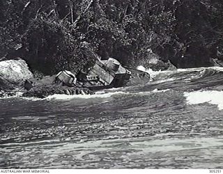 NEW GUINEA. A WRECKED JAPANESE PATROL BOAT AT THE MOUTH OF THE KAPUGARA RIVER. (NAVAL HISTORICAL COLLECTION)