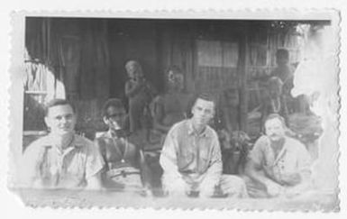 [Scranton Harrington, Servicemen, and Bougainvilleans Outside Hut]
