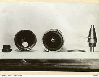 PORT MORESBY, PAPUA, NEW GUINEA, 1944-03-04. THE DISMANTLED VIEW OF A CAPTURED JAPANESE 75MM SHELL WITH FUSE. THE FINDING OF THIS HOLLOW CHARGE PROJECTILE SHOWED A RADICAL CHANGE IN JAPANESE ..