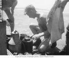 Dr. Arthur D. Welander sorting dead fish, Bikini Atoll, summer 1947