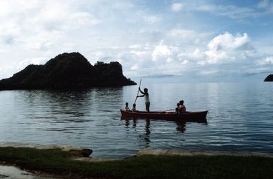 A villager from Palau and his family head out to an island to fish
