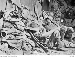 AT SEA, 1944-04-24. TROOPS OF THE 8TH INFANTRY BRIGADE RESTING ABOARD AN LCM (LANDING CRAFT MECHANIZED) EN ROUTE FOR MADANG EIGHT HOURS FROM SAIDOR