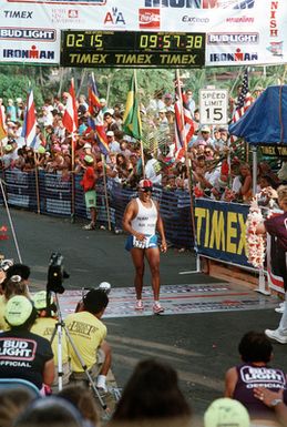 2LT Michael Buonaugurio runs across the finish line at the 1989 Ironman Triathlon. Buonaugurio, a shift leader with the 15th Air Base Wing security police at Hickam Air Force Base, placed 215th out of 1,246 participants in the race, which features a 2.4-mile swim and a 112-mile bicycle ride and 26.2-mile marathon run