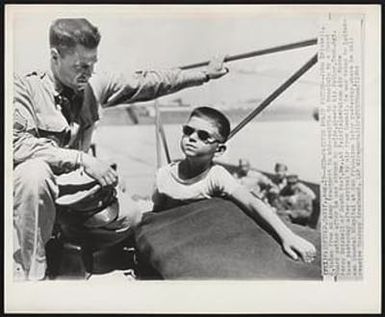 Mid-Pacific Polio Victim--John Driskell, 6, taken from an Army transport in mid-pacific to Honolulu by a Coast Guard cutter after he was struck by polio, greets his father, Tech. Sgt. Percy Driskell of South Port, Me., at Fairfield-Suisun Air Force base yesterday after arrival by air from Hawaii. He was taken to Letterman General Hospital at San Francisco later yesterday, where he will receive therapy treatment.