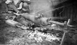 Christmas dinner pig being roasted on Bougainville, 1944