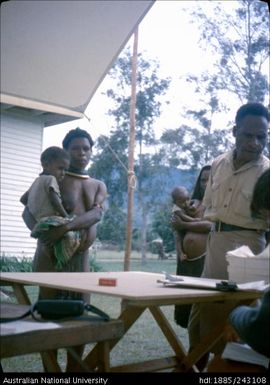 Mother and child collecting ballot paper