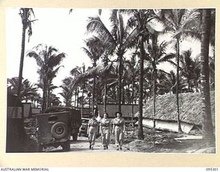 PALMALMAL PLANTATION, JACQUINOT BAY, NEW BRITAIN, 1945-08-14. AUSTRALIAN ARMY NURSING SERVICE SISTERS WALKING ALONG A ROAD IN THE GROUNDS, 2/8 GENERAL HOSPITAL