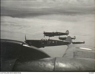 BISMARCK ARCHIPELAGO. 1944-03-28. AIRCRAFT, CODE NAMED UP-T, UP-S, UP-C AND UP-W, OF NO. 79 (SPITFIRE) SQUADRON RAAF, IN FLIGHT OVER NEW BRITAIN EN ROUTE FROM KIRIWINA TO THE ADMIRALTY ISLANDS. ..