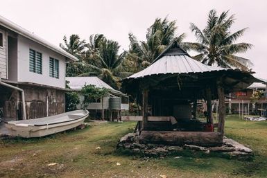 House with water tank foundation next to fale, Nukunonu, Tokelau