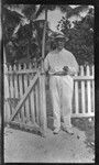 Sylvester Lambert smoking by a gate
