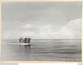 BOUGAINVILLE. 1945-05-11. AUSTRALIAN LANDING CRAFT 15, OPERATED BY 42 LANDING CRAFT COMPANY, TRAVELLING WITH SUPPLIES FROM TOROKINA TO SORAKEN. THE 42-MILE JOURNEY TAKES APPROXIMATELY 7 HOURS