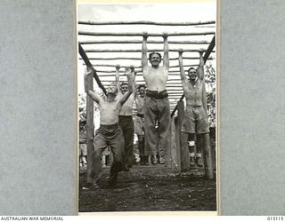 1943-06-26. NEW GUINEA. AT A CONVALESCENT CAMP SOMEWHERE IN NEW GUINEA. PHYSIOTHERAPY TREATMENT IS GIVEN TO RESTORE INJURED MUSCLES AND NERVES. AN OVERHEAD LADDER SEVEN FEET HIGH WITH RUNNERS 12 ..