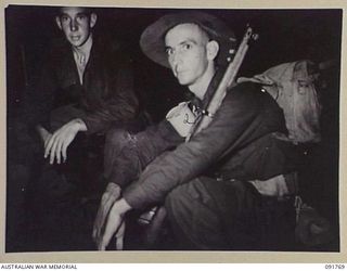 BOUGAINVILLE, 1945-05. MEMBERS OF 26 INFANTRY BATTALION (A.I.F.) PRIOR TO EMBARKING FOR A NIGHT LANDING ON TOROKORI ISLAND IN MATCHIN BAY. IDENTIFIED PERSONNEL ARE:- PTE W.J. BORTHISTLE, RIFLEMAN ..