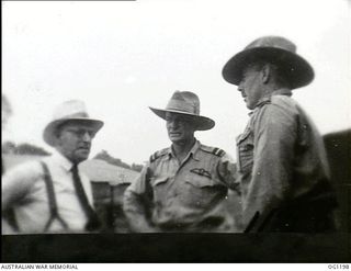AITAPE, NORTH EAST NEW GUINEA. C. 1944-06. ARTHUR DRAKEFORD, THE MINISTER FOR AIR (LEFT), AIR COMMODORE F. R. W. SCHERGER, THE AIR OFFICER COMMANDING NO. 10 GROUP RAAF (CENTRE) AND GROUP CAPTAIN W. ..