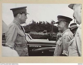 LAE, NEW GUINEA. 1945-03-26. LORD WAKEHURST, GOVERNOR OF NEW SOUTH WALES (1), WITH LIEUTENANT GENERAL V.A.H. STURDEE (2), AND BRIGADIER F.E. WELLS (3), FOLLOWING HIS ARRIVAL AT THE AIRSTRIP ON A ..