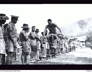 PORT MORESBY, PAPUA, 1942-07. A COMPETITOR IN THE HOP-STEP-AND-JUMP EVENT AT A COMBINED SPORTS MEETING HELD BY AUSTRALIAN TROOPS IN NEW GUINEA. A JAPANESE AIR-RAID TEMPORARILY HELD UP PROCEEDINGS ..