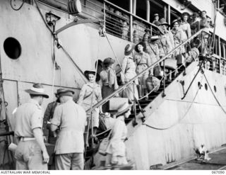 TOWNSVILLE, NORTH QUEENSLAND, AUSTRALIA. 1944-06-27. AUSTRALIAN ARMY MEDICAL WOMEN'S SERVICE PERSONNEL DISEMBARKING FROM THE H.M.T. "ORMISTON" ON THEIR RETURN TO AUSTRALIA FROM NEW GUINEA