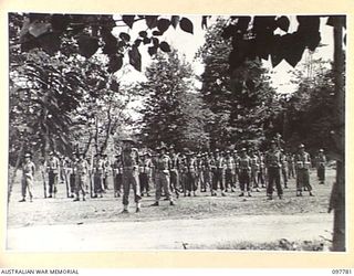 NAMANULA, NEW BRITAIN, 1945-10-08. MEMBERS OF 11 DIVISION SIGNALS ON PARADE DURING AN INSPECTION OF THE UNIT BY MAJ-GEN K.W. EATHER, GOC 11 DIVISION
