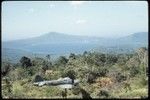 Rabaul Coastwatcher's Memorial, World War 2-era airplane displayed, caldera and volcanic peaks in background