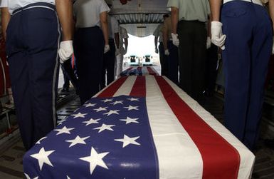 During a commemorative ceremony at Hickam Air Force Base (AFB) Hangar 35, inside a US Air Force (USAF) C-17A Globemaster III, members of a joint honor guard prepare to carry the remains believed to be of unaccounted-for Americans, recovered in Vietnam and Papua New Guinea. The remains will be taken to the Joint POW/MIA Accounting Command's Central Identification Laboratory (JPAC CIL) where they will attempt to positively identify the remains so they can be returned to their families