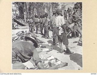 MOUNT SHIBURANGU, WEWAK AREA, NEW GUINEA. 1945-09-21. TROOPS OF 18 JAPANESE ARMY, AT A CONTROLLING POINT AT MAKOW ON THE TOP OF MOUNT SHIBURANGU, PACKING THEIR EQUIPMENT AFTER IT HAS BEEN SEARCHED ..