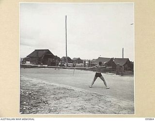 BORAM BEACH, WEWAK AREA, NEW GUINEA. 1945-08-31. PERSONNEL OF 8 INFANTRY BRIGADE PLAYING A DOUBLES MATCH OF PAT TENNIS