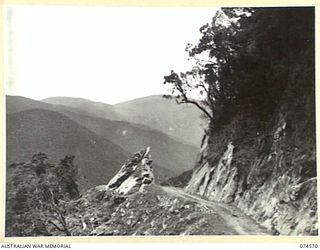 NEW GUINEA. 1944-07-09. A SECTION OF THE WAU-BULLDOG ROAD AS IT PASSES ALONG THE TOP OF A HIGH RIDGE