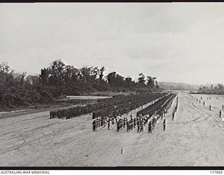 TOROKINA, BOUGAINVILLE. 1945-10-29. MEMBERS OF 3RD DIVISION DRAWN UP ON THE PIVA AIRSTRIP FOR AN INSPECTION BY THE COMMANDER IN CHIEF, AUSTRALIAN MILITARY FORCES