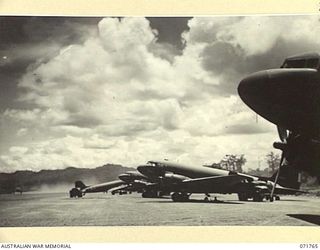 LAE, NEW GUINEA, 1944-03-27. DOUGLAS C47 DAKOTA TRANSPORT AIRCRAFT OF THE UNITED STATES ARMY AIR FORCE ALONGSIDE THE AIRSTRIP AT LAE AERODROME