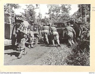 WEWAK AREA, NEW GUINEA. 1945-05-30. ON BIG ROAD FROM SAURI TO WEWAK, NEAR BORAM AIRSTRIP, WHICH IS UNDER CONSTRUCTION, A LARGE AMOUNT OF ENEMY EQUIPMENT HAS BEEN RECOVERED INCLUDING LORRIES, STAFF ..