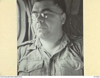 MILNE BAY, NEW GUINEA. 1944-04-22. VX94717 COLONEL R.J. WRIGHT, SCIENTIFIC CONSULTANT, DIRECTORATE OF ARMY RESEARCH, SEATED ABOARD A RAAF LOCKHEED HUDSON AIRCRAFT WHICH CONTAINS THE OFFICIAL PARTY ..