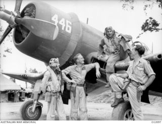 PIVA AIRFIELD, TOROKINA, BOUGAINVILLE ISLAND, SOLOMON ISLANDS. C. 1945-01-16. AIRCREW PERSONNEL OF THE RAAF AND ROYAL NEW ZEALAND AIR FORCE COMPARING NOTES AROUND THE NEW ZEALAND CORSAIR AIRCRAFT, ..