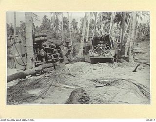 HANSA BAY, NEW GUINEA. 1944-06-17. JAPANESE ARMY TRUCKS WHICH JUST MISSED A DIRECT HIT BY A LARGE ALLIED AERIAL BOMB