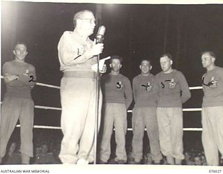 MADANG, NEW GUINEA. 1944-09-16. LIEUTENANT-COLONEL SIR DONALD CAMERON, KCMG, DSO, VD, CHAIRMAN OF THE RAAF RECRUITING COMMITTEE (NSW) (1) INTRODUCING THE RAAF BOXING AND WRESTLING TROUPE TO THE ..