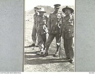 DUMPU, NEW GUINEA. 1943-12-19. VX9 MAJOR GENERAL G. A. VASEY, CB., CBE., DSO., GENERAL OFFICER COMMANDING 7TH AUSTRALIAN DIVISION (2) EXPLAINS THE AUSTRALIAN POSITIONS IN THE FINISTERRE AREA TO THE ..