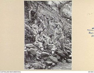 LAE, NEW GUINEA, 1945-05-18. PERSONNEL FROM AUSTRALIAN WOMEN'S ARMY SERVICE BARRACKS SITTING ON THE BANKS OF THE BUSU RIVER DURING A TOUR OF THE AREA CONDUCTED BY ARMY AMENITIES SERVICE FOR ..