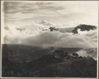 Scenes at Ononge [A village with church in the clouds] Frank Hurley