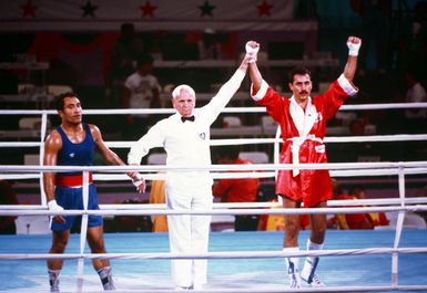 Army SPECIALIST Fourth Class Aristedes Gonzalez, right, representing Puerto Rico, is declared the winner of the boxing match with Paulo Tuvale of Western Samoa during the 1984 Summer Olympics