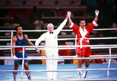 Army SPECIALIST Fourth Class Aristedes Gonzalez, right, representing Puerto Rico, is declared the winner of the boxing match with Paulo Tuvale of Western Samoa during the 1984 Summer Olympics