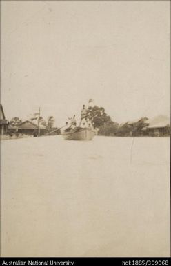 Whale boat being poled down Nausori street