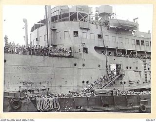 TOROKINA, BOUGAINVILLE. 1945-07-26. THE FIRST CONTINGENT OF "FIVE YEAR RELEASE PERSONNEL" TO LEAVE FOR THE RETURN TO AUSTRALIA. THE MEN, WHO HAVE COMPLETED FIVE YEARS IN THE ARMY, ARE BOARDING THE ..