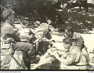 TADJI NEAR AITAPE, NORTH EAST NEW GUINEA. C. 1944-12-25. MEMBERS OF THE RAAF SIGNALS UNIT TRANSMITTING MESSAGES TO REAR HEADQUARTERS. SUCH COMMUNICATION WAS SET UP ONE HOUR AFTER LANDING ON THE ..