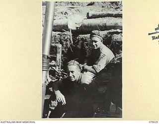 TSIMBA RIDGE, BOUGAINVILLE ISLAND. 1945-02-06. PERSONNEL OF NO 7 MORTAR DETACHMENT, 101ST BRIGADE SUPPORT COMPANY ENJOYING A SMOKE BETWEEN SHOOTS WHILE SUPPORTING THE ATTACK ON ENEMY POSITIONS BY ..