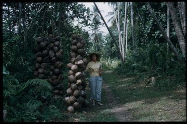 On patrol (Margaret Spencer with coconut harvest) : Goodenough Island, D'Entrecasteaux Islands, Papua New Guinea, 1956-1958 / Terence and Margaret Spencer