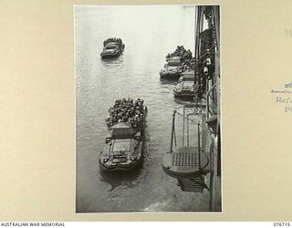 MILFORD HAVEN, LAE, NEW GUINEA. 1944-11-01. TROOPS OF THE 4TH FIELD REGIMENT COMING ABOARD THE AMERICAN LIBERTY SHIP, LINDLEY M. GARRISON FOR THE UNIT MOVEMENT TO BOUGAINVILLE ISLAND