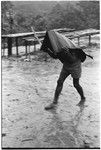 Running from the rain under a mode pandanus umbrella