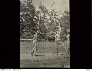 MADANG, NEW GUINEA. 1944-12-28. IN TYPICAL NEW GUINEA CRICKET ATTIRE, BARE-CHESTED 254424 FLIGHT LIEUTENANT PETER CAHILL, NORTH SYDNEY, NSW, SENDS DOWN A "HOT ONE". CRICKET IS PART OF THE ORGANISED ..