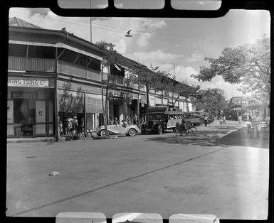 Road scene at Papeete, Tahiti, showing loaded buses with people on the street