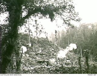 THE SOLOMON ISLANDS, 1945-03-27. AN AUSTRALIAN ARMY MORTAR POST SHOWING MORTAR POSITIONS AND THE CREWS' CAMPSITE. PHOTOGRAPH TAKEN ON BOUGAINVILLE ISLAND AS ONE OF THE WEAPONS FIRES. (RNZAF ..