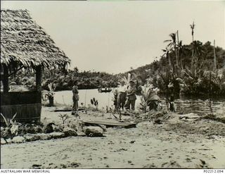 Aitape, New Guinea. 1945-01. Sisters of the 2/11th Australian General (2/11AGH) stand outside their Mess. In an area prone to flooding note how close the Aitape River is and also the need for ..